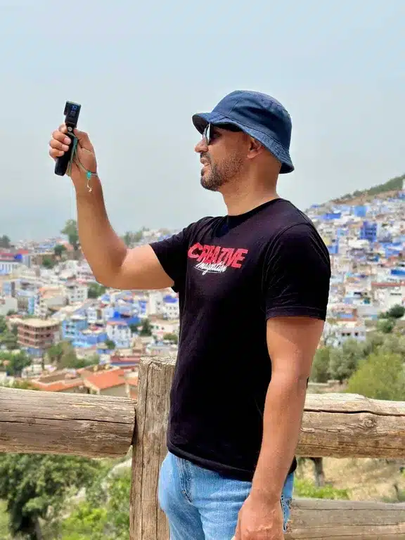 Majdi with a camera while traveling